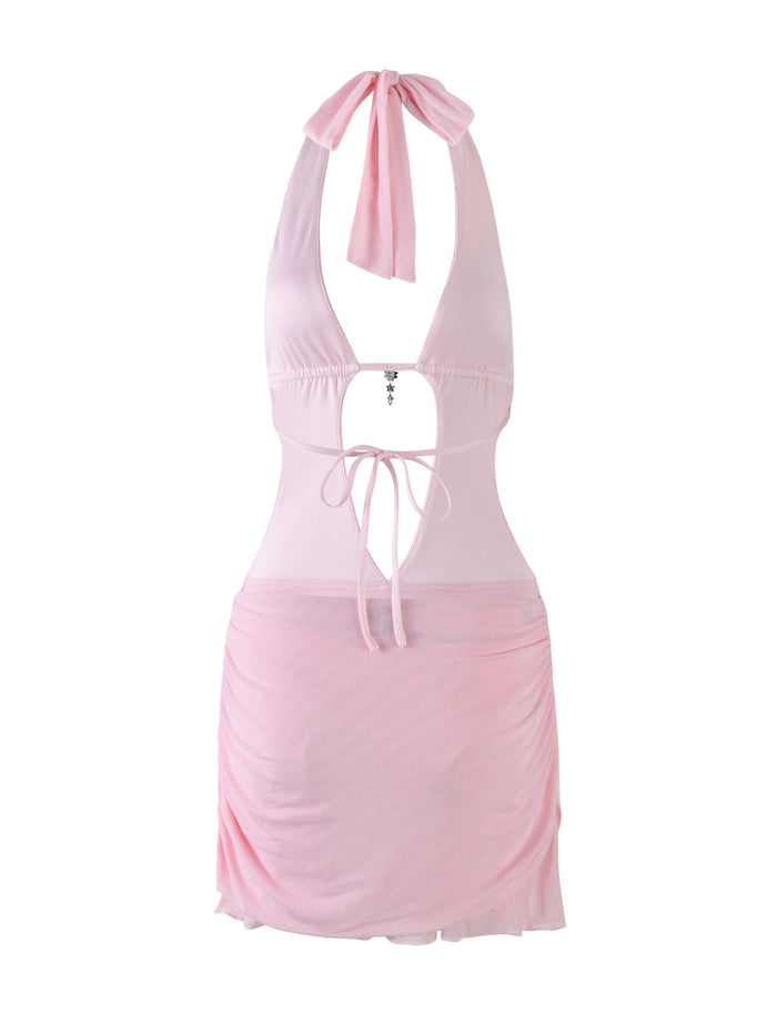 The ESHA DRESS - PINK by TIGERMIST is a baby pink halter-neck mini dress featuring a deep plunge neckline, bodycon fit, adjustable neck and waist ties, central jewel detail, and ruched mesh skirt overlay.