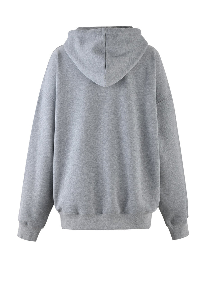 A back view of the LUMEN HOODIE - GREY by TIGERMIST. This hoodie features a relaxed fit with long sleeves, ribbed cuffs, and a ribbed hem. The fabric appears to be soft and comfortable, maintaining the brand's signature quality. There are no visible logos or designs on the hoodie.