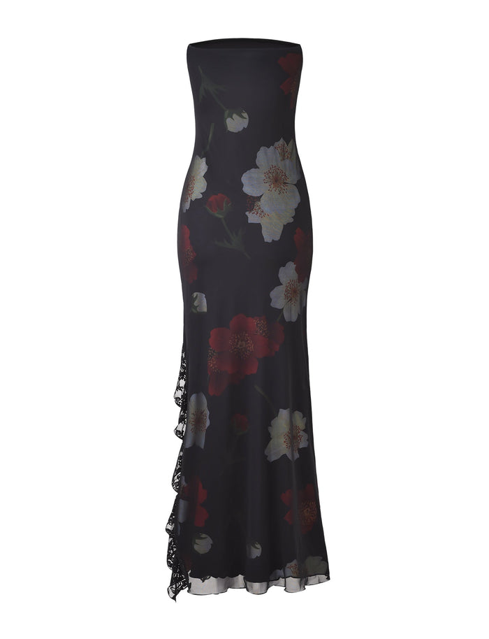 Introducing the THEO MAXI DRESS - RED : MACRO FLORAL from TIGERMIST. This strapless, floor-length dress showcases a form-fitting silhouette crafted from black fabric adorned with large white and red floral patterns. A side slit with lace detailing adds an elegant touch to the gown.