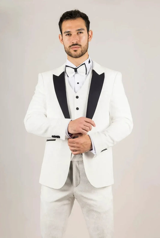 Men's white tuxedo suit with black lapels, bow tie, and tailored fit, ideal for formal events like weddings and parties.