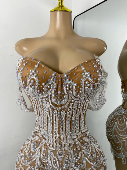 Shine in the Claren pearl and rhinestone off-the-shoulder mesh bodycon mini dress. Perfect for birthdays, parties, and special occasions.
