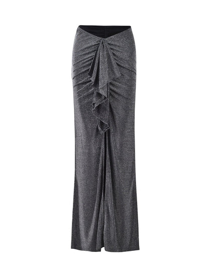 The DAISIE SKIRT by TIGERMIST is a high-waisted black shimmer skirt that features a ruffled design down the center front, adding texture and elegance. It flares slightly at the hem, creating a sophisticated silhouette with its soft and flowy fabric.
