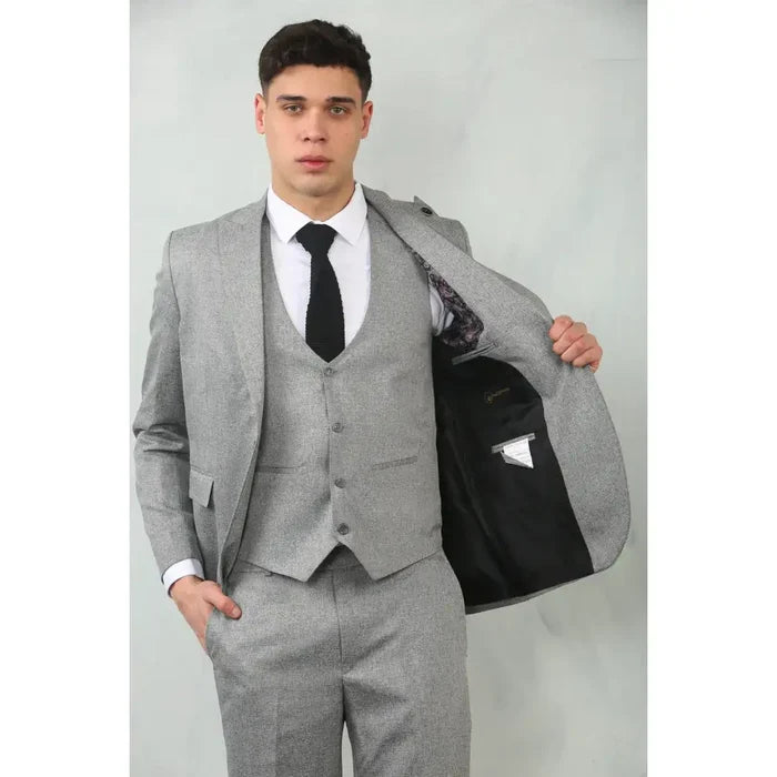 Front view of a young man wearing a grey tailored fit wedding 3-piece suit with a white shirt and black tie, showing the suit's slim silhouette and modern style.