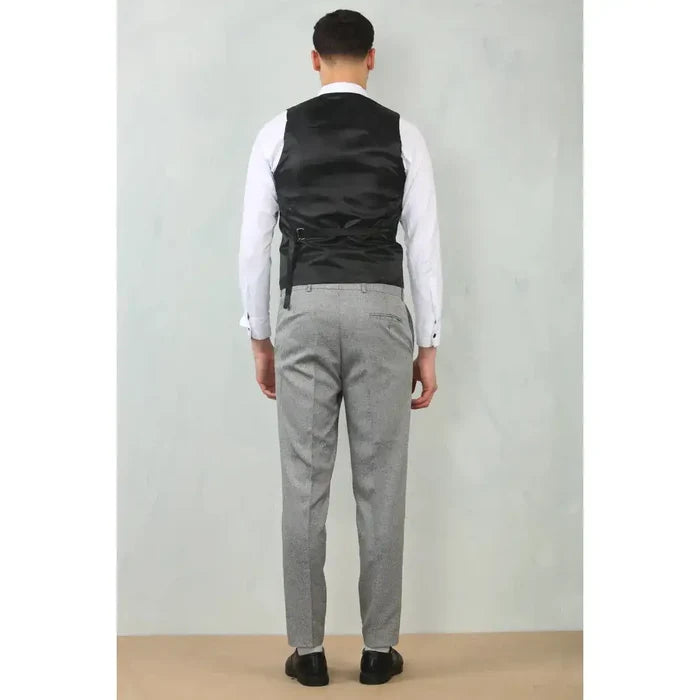 Men's grey tailored fit wedding 3 piece suit with matching trousers, worn with a white dress shirt and black shoes, back view