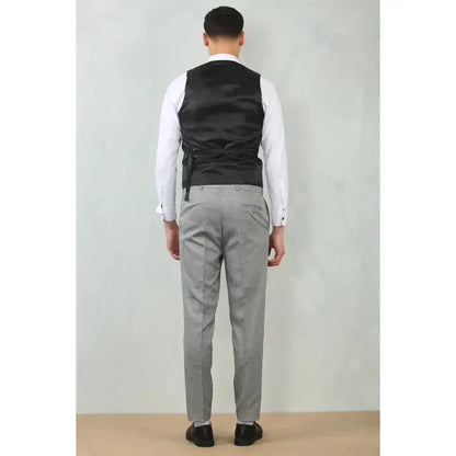 Men's grey tailored fit wedding 3 piece suit with matching trousers, worn with a white dress shirt and black shoes, back view