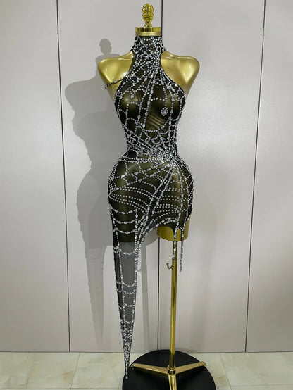 Sparkle in the Jaila rhinestone mesh asymmetric bodycon mini dress. Sexy party dress for birthdays, clubs, cocktail parties, and special events.