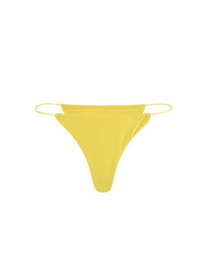 A vibrant neon yellow Kryze bikini bottom with thin side straps and a minimalist design from TIGERMIST, photographed against a plain white background.