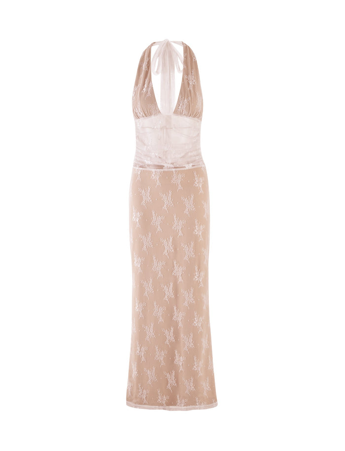 The LENORA LACE DRESS by TIGERMIST is a sleeveless, form-fitting white dress featuring a halter neckline and a semi-sheer bodice with a floral lace overlay. The lower portion of this stunning creation is adorned with an intricate, embroidered floral pattern.