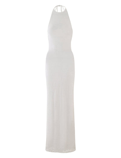 The LUCIA DRESS - WHITE : LACE from TIGERMIST is a sleeveless, floor-length dress with a halter neckline. It boasts an elegant, form-fitting design along with a subtle textured lace pattern throughout the fabric. The back features thin straps that tie at the neck for added sophistication.