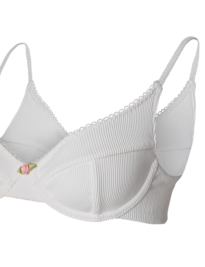 The MILANA BIKINI TOP - WHITE by TIGERMIST is a white ribbed balconette bikini top with underwire, thin adjustable straps, and a pink rose detail at the center front.