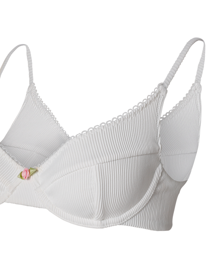 The MILANA BIKINI TOP - WHITE by TIGERMIST is a white ribbed balconette bikini top with underwire, thin adjustable straps, and a pink rose detail at the center front.