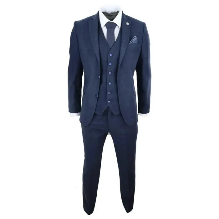 Close-up of navy blue wool tweed men's suit with white shirt and matching tie, detailed fabric and lapel.
