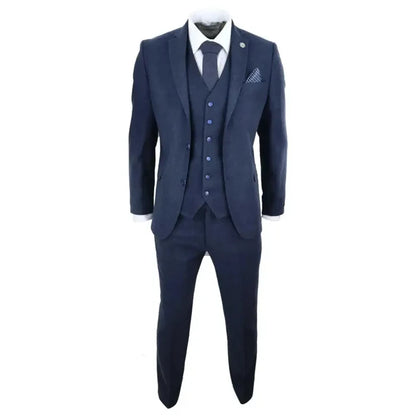 Close-up of navy blue wool tweed men's suit with white shirt and matching tie, detailed fabric and lapel.