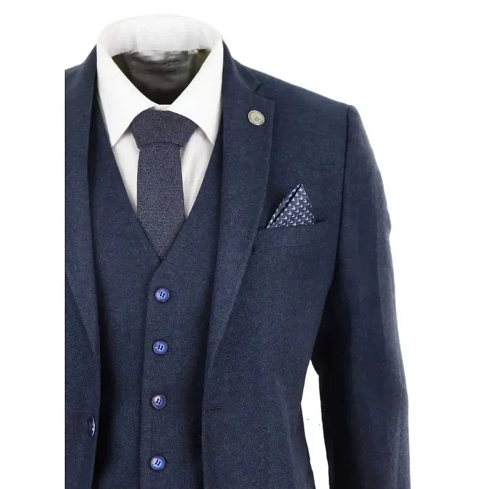 Close-up of men's navy blue wool tweed suit with white dress shirt, matching tie, and pocket square, tailored for formal occasions
