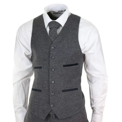Men's grey wool tweed three-piece suit with tailored fit, includes blazer, waistcoat, and trousers, styled with a white shirt and matching tie