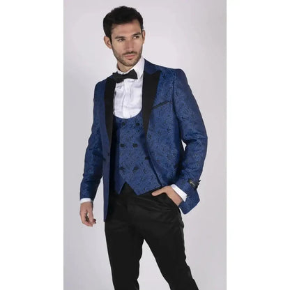 Male model wearing blue paisley tuxedo blazer and waistcoat with black trousers, white shirt, and black bow tie, stylish formal attire
