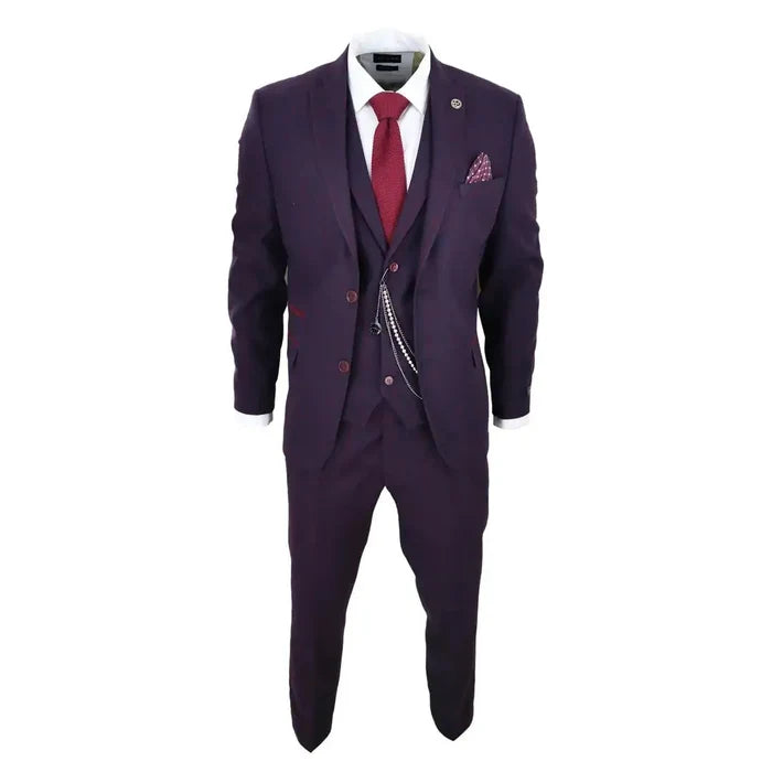 Close-up of men's plum wine check wool tweed suit jacket with notch lapel, red accents, and decorative chain accessory, emphasizing fabric details.