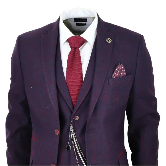 Men's 3 piece suit in plum wine check wool tweed with notch lapel, white dress shirt, red tie, pocket square, and lapel pin, tailored for formal occasions