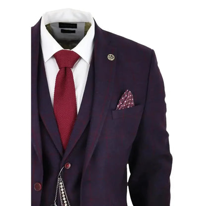 Men's tailored suit jacket in dark plum wine tweed with subtle check pattern, featuring a lapel pin, pocket square, and a red textured tie