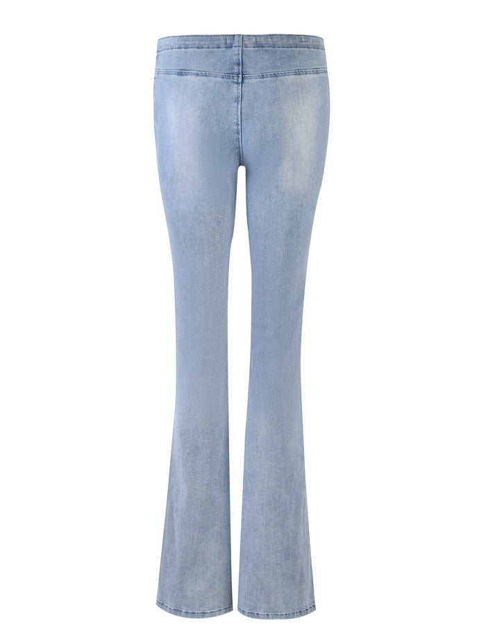 The TIJANA JEAN - BLUE : DENIM BLUE from TIGERMIST features a back view showcasing light blue, high-waisted bell-bottom jeans. The denim exhibits a slightly faded, worn look with flared legs that widen from the knee to the hem. The fit is snug through the waist and hips.