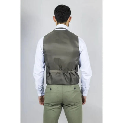 Back view of a man wearing a men's sage green 3-piece linen summer wedding suit with a vest, white shirt, and khaki pants, standing against a plain background.