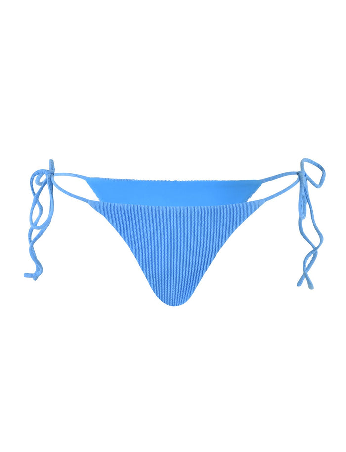 The YVE BIKINI BOTTOM - BLUE : ROYAL BLUE from TIGERMIST is a pair of blue ribbed bikini bottoms with adjustable side ties. The fabric has a textured appearance, and the design features a classic cut. The ties are shown in bows on each side, allowing for a customizable fit.